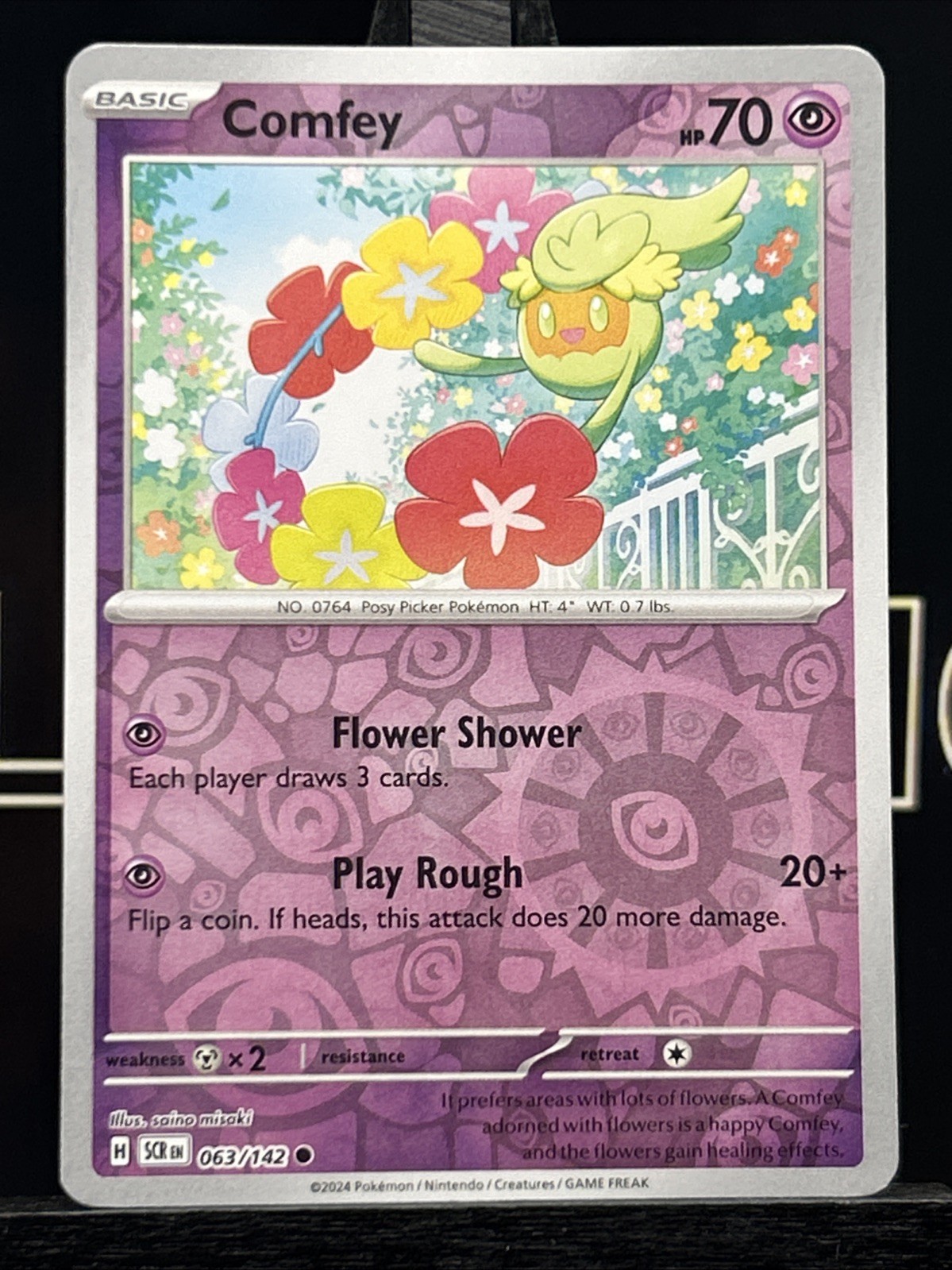 Comfey 063/142 Surging Sparks Reverse Holo Pokémon Card